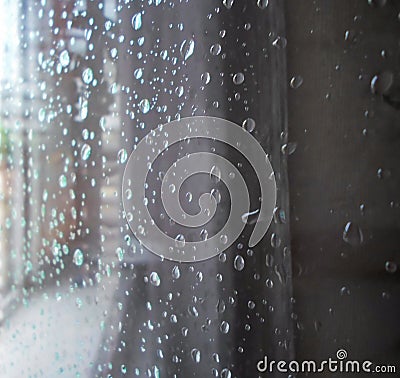 Raindrops on a window pane. Drops of water on a metal surface, on a window pane, Window in a house in rainy time Stock Photo