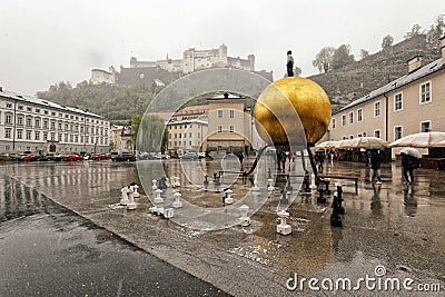 Rainy day on Salzburg square with golden globe Editorial Stock Photo