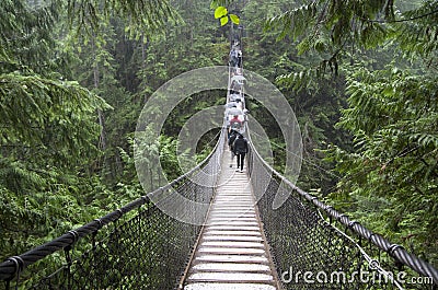 Rainy day suspension bridge walk Editorial Stock Photo