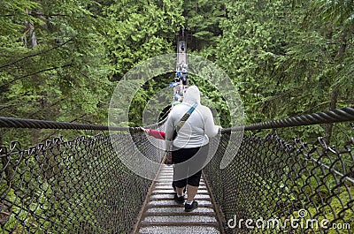 Rainy day suspension bridge walk Editorial Stock Photo