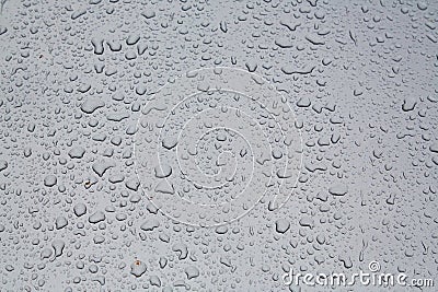 Rainy drops on glass surface. Liquid droplets shape background. Raindrops on window. Autumn weather concept, copy space Stock Photo