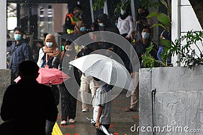 rainy season in jakarta people wear umbrellas Editorial Stock Photo