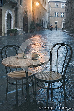 Rainy street cafe in old European town Stock Photo