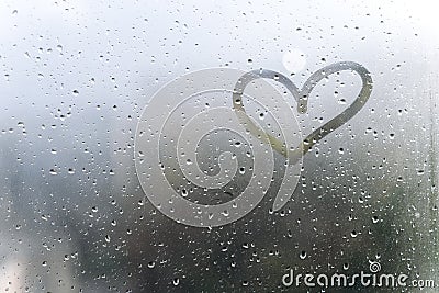 Rainy weather, the inscription heart on the sweaty glass Stock Photo