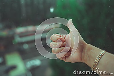 Rainy weather, rain drops falling on womans hand. Rain is dropping on a man`s hand. Stock Photo