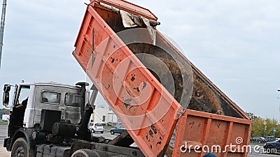 Raised bucket of a truck, unloading sand Editorial Stock Photo