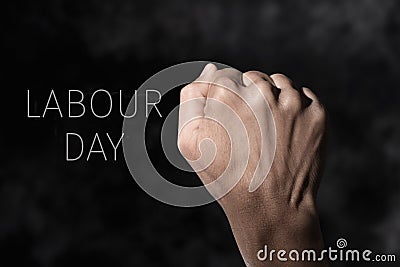 Raised fist and text labour day Stock Photo