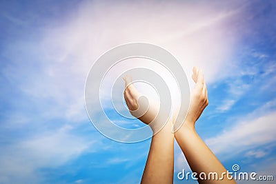 Raised hands catching sun on blue sky. Concept of spirituality, Stock Photo