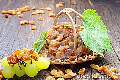 Raisin in a wicker basket and grapes Stock Photo