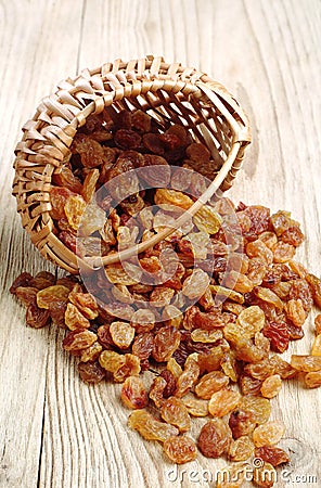 Raisin in a wicker basket and near Stock Photo