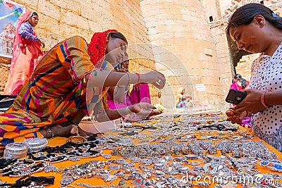 Rajasthani women selling and negotiating price of jewelleries with female tourist Editorial Stock Photo