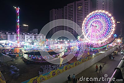 Rajkot, Gujarat, India, 06-09-2023, Electric Nights at the Carnival: Enchanting Rides with Big Ferris Wheel Energetic Crowds Under Editorial Stock Photo
