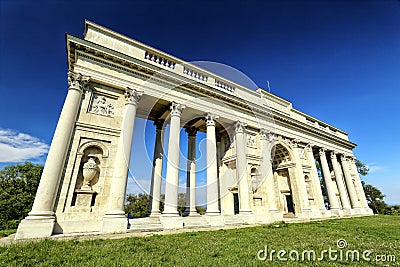 Rajstna colonnade in the middle of the grass field in strong perspective Stock Photo