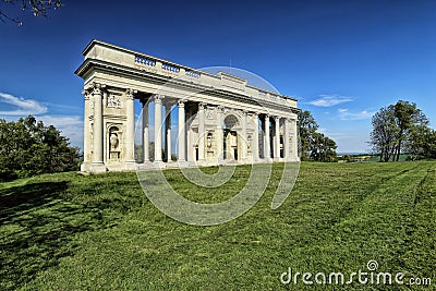 Rajstna colonnade in the middle of the grass field Stock Photo