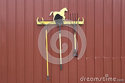 Rake, shovel, and pitchfork on a rack Stock Photo