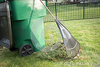 Raking up grass cuttings in spring Stock Photo