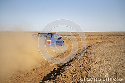 a rally sport car driving on the drit gravel race, fast speed with mud splash Stock Photo