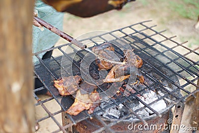Ram meat being roasted on a barbecue spit Stock Photo