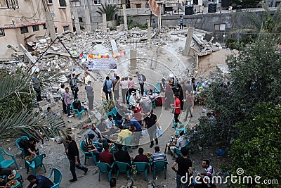 Ramadan breakfast over the rubble of houses demolished by Israeli warplanes during the last round Editorial Stock Photo