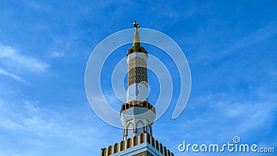 Beautiful white tower mosque in the sunlight. Stock Photo