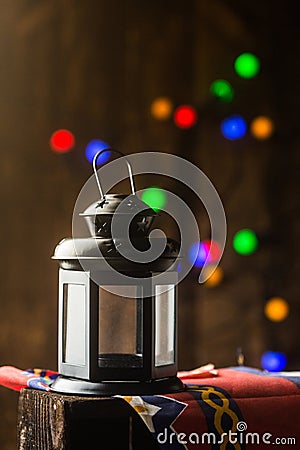 Ramadan lantern with bokeh dotes and ramadan themed cloth shot on dark wood Stock Photo