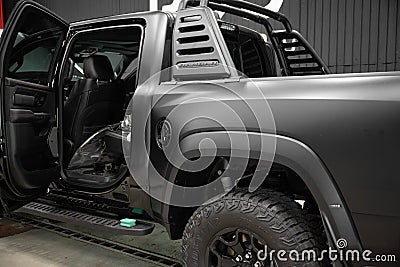 Rambar car, covered with protective matte black paint film, is in repair shop Editorial Stock Photo