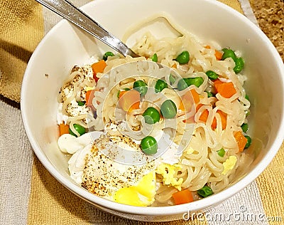 Ramen noodle variation with carrot, pea and egg. Stock Photo