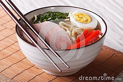 Ramen noodles with pork and egg in a bowl close up. Horizontal Stock Photo