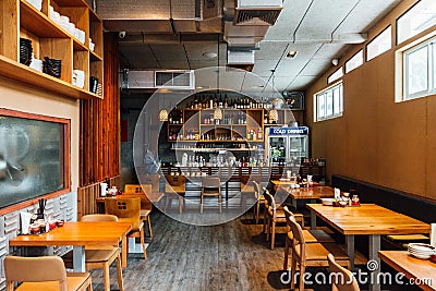 Ramen restaurant with tables and seats. Mostly decorated with oak wood that feels warm and cozy Editorial Stock Photo