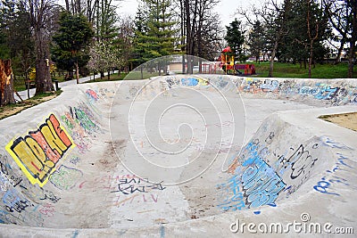 Ramnicu Valcea, Romania - 02.04.2019 - skating skate park skatepark design skateboard skateboarding empty concrete with graffiti Editorial Stock Photo