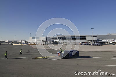 Ramp Agents Returning an Aircraft Tug Truck to Gate at JFK Airport Editorial Stock Photo