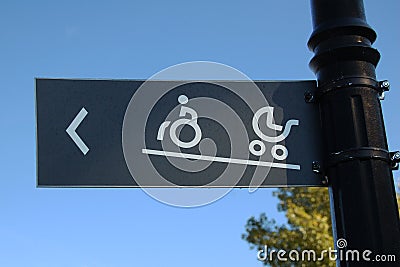 Ramped access, using wheelchair ramp with information sign Stock Photo