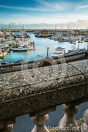 Ramsgate Royal Harbour seen beyond the balustrades of the Royal Parade in the Isle of Thanet, Kent, UK Stock Photo