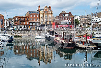 Ramsgate Royal Harbour with waterside impressive architecture reflecting in the harbour basin alongside Editorial Stock Photo