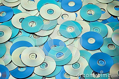 Random arrangement of metallic DVD and CD data storage disks Stock Photo