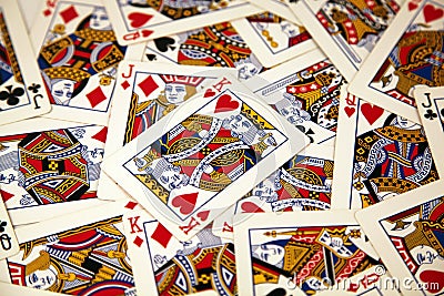 Random playing cards of kings, queens and jacks together forming a background Stock Photo