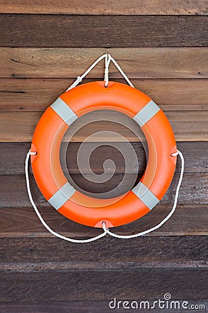 Ðžrange lifebuoy on wooden wall Stock Photo