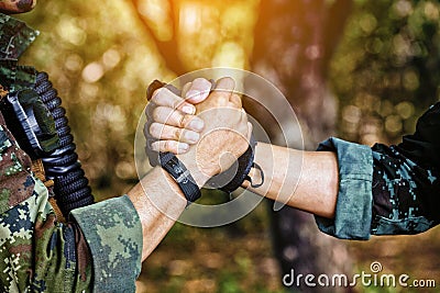 Rangers celebrating success, clapping with hands. Team work conceptual image. Soldier shaking hands . People and military concept Stock Photo