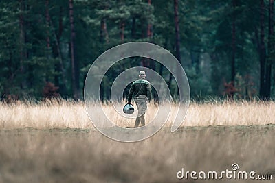 Rangers with feeding bucket in field. National Park Hoge Veluwe. Editorial Stock Photo