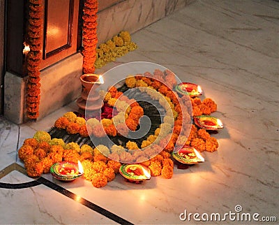 Flower colourful rangoli with diya decorations Stock Photo