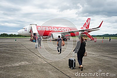 Passengers, tourists, travelers carrying luggage on board the plane. Editorial Stock Photo