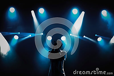 Rap singer with microphone on stage in music hall Editorial Stock Photo