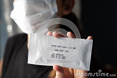 Rapid sars-cov-2 blood test for self testing. Woman holds a kit of fast covid 19, coronavirus test Stock Photo