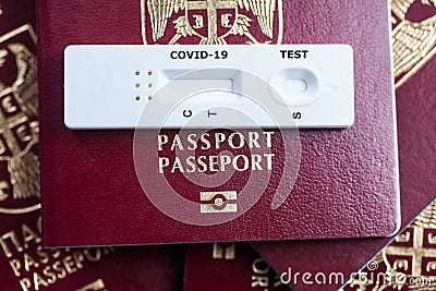 Rapid serology COVID-19 test cassette on red biometric passport Stock Photo