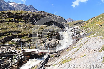 Rapid stream, bridge and mountain panorama, Hohe Tauern Alps, Austria Stock Photo