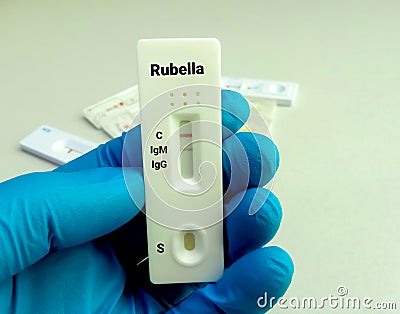 Rapid test cassette for Rubella Virus rapid screening test, showing positive IgM result. Stock Photo