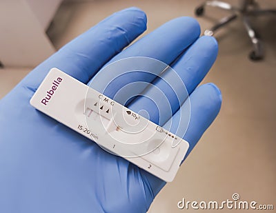 Rapid test device or cassette for Rubella (German measles) test showing positive result. Stock Photo