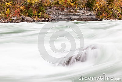 Rapids Flow Over a Rock in Niagara Gorge, Canada Stock Photo