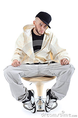 Rapper sits on chair and looks at camera Stock Photo