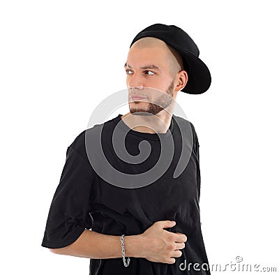Rapper wearing black t-shirt and hat looks into distance Stock Photo